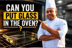 Chef in a white uniform holding a clear glass baking dish beside an oven, with the headline “Can You Put Glass in the Oven?” and safety tips about using oven-safe glass, preventing cracks, and heating glass safely.